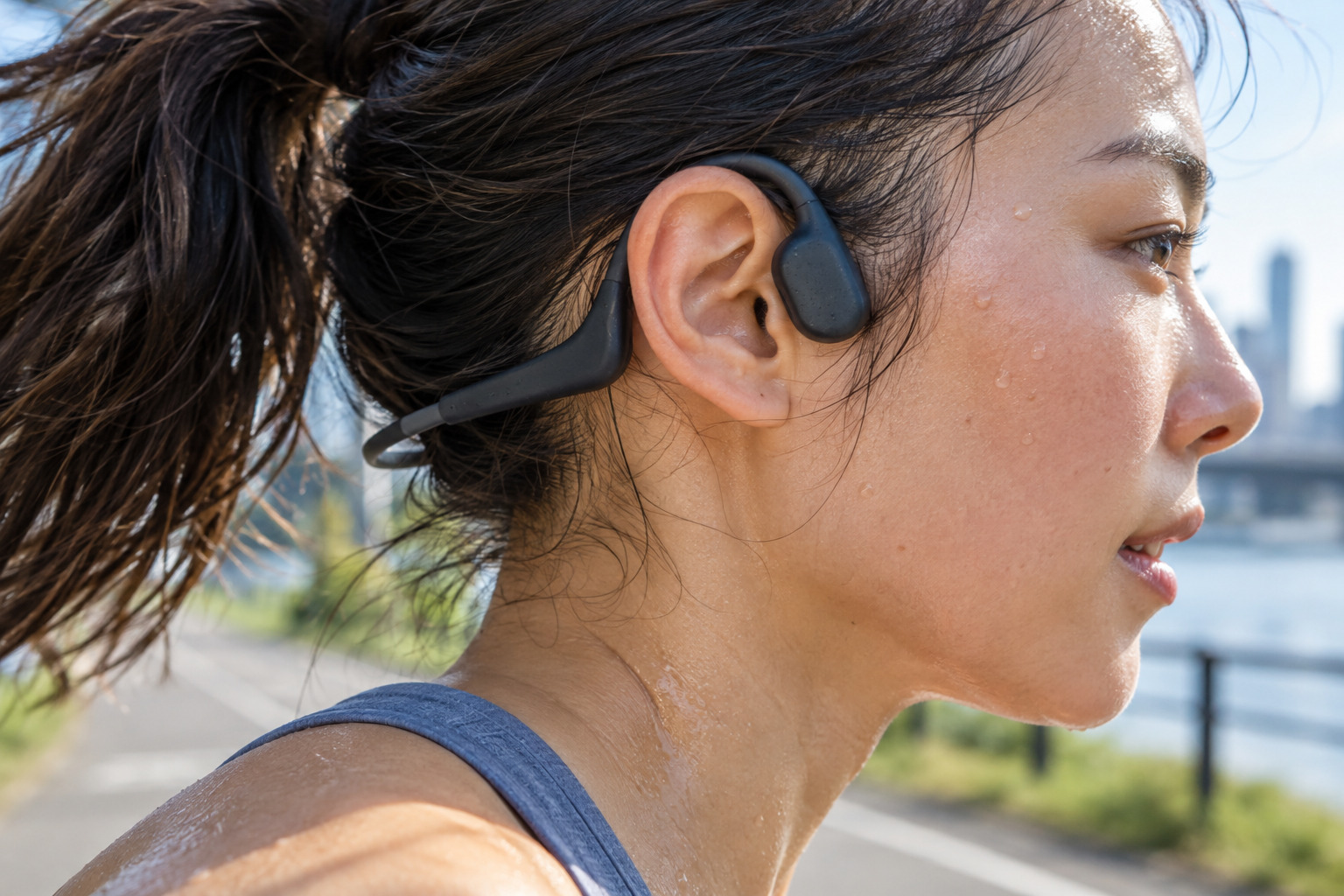 Close-up of open-ear sport headphone fit during a run